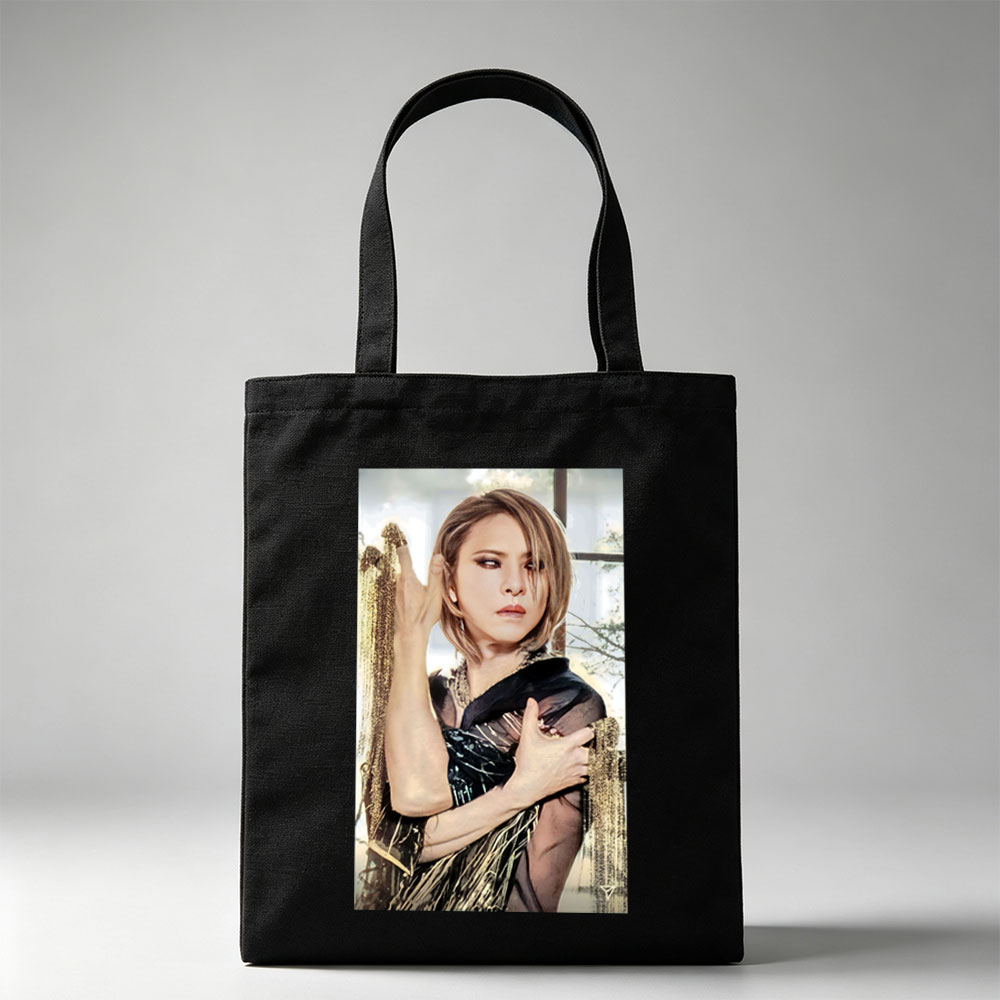 Cher in a Dramatic Pose Wearing a Black and Gold Outfit with Flowing Fabric - Canvas tote bags