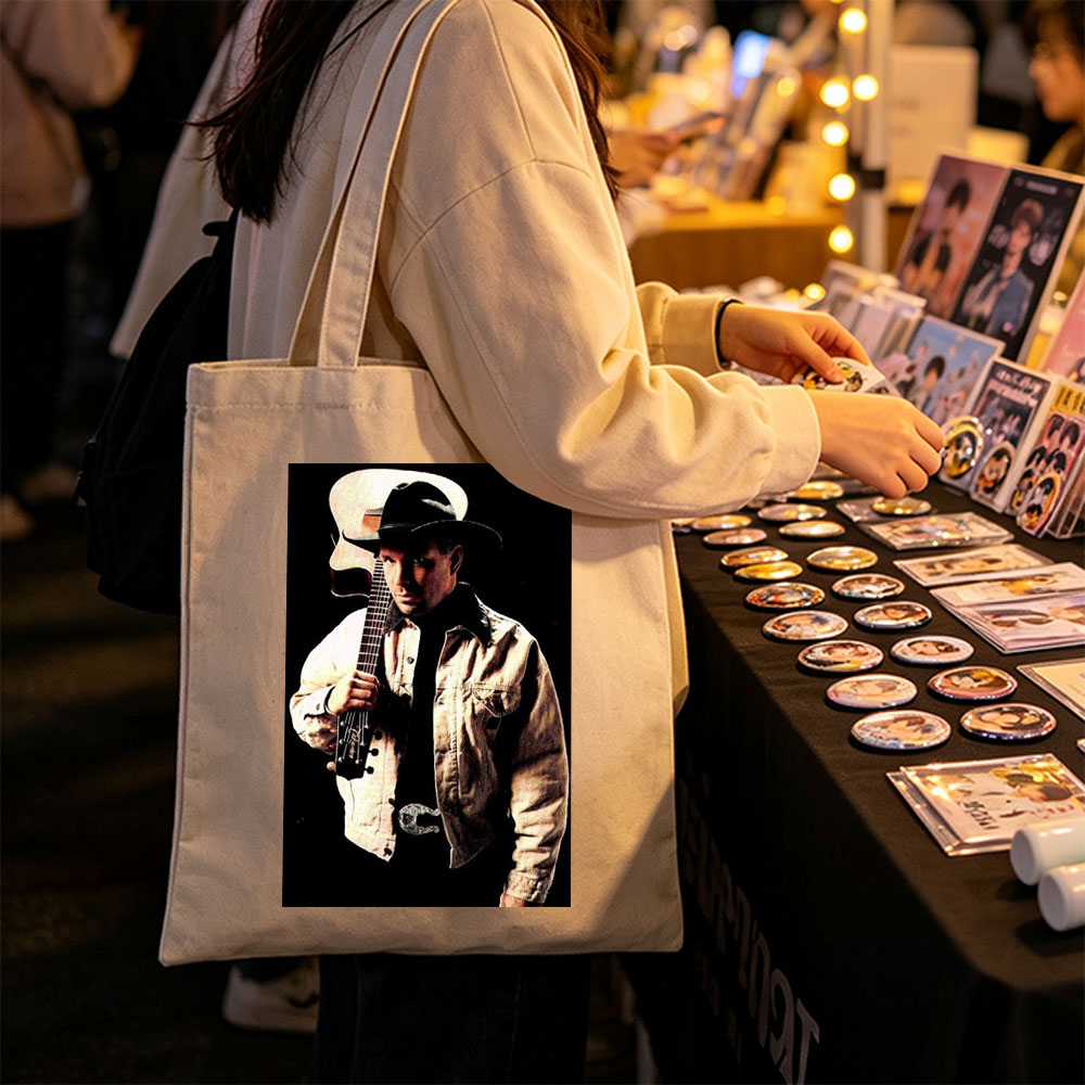 Garth Brook Holding Acoustic Guitar in Cowboy Attire Against Dark Background - Canvas tote bags