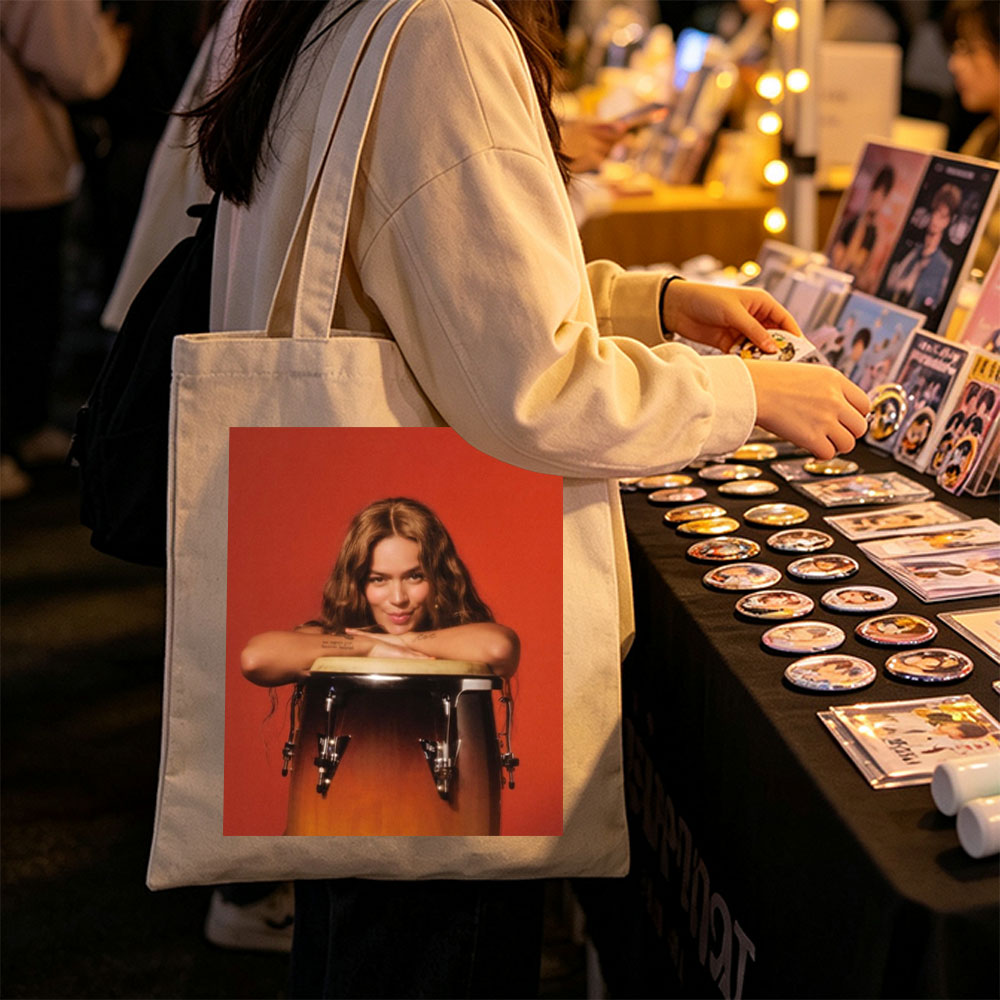 Maren Morris Leaning on a Conga Drum Against a Red Background - Canvas tote bags