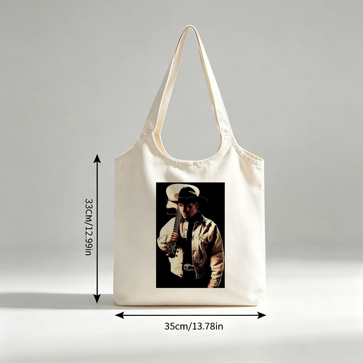 Garth Brook Holding Acoustic Guitar in Cowboy Attire Against Dark Background - Canvas shoulder bags/