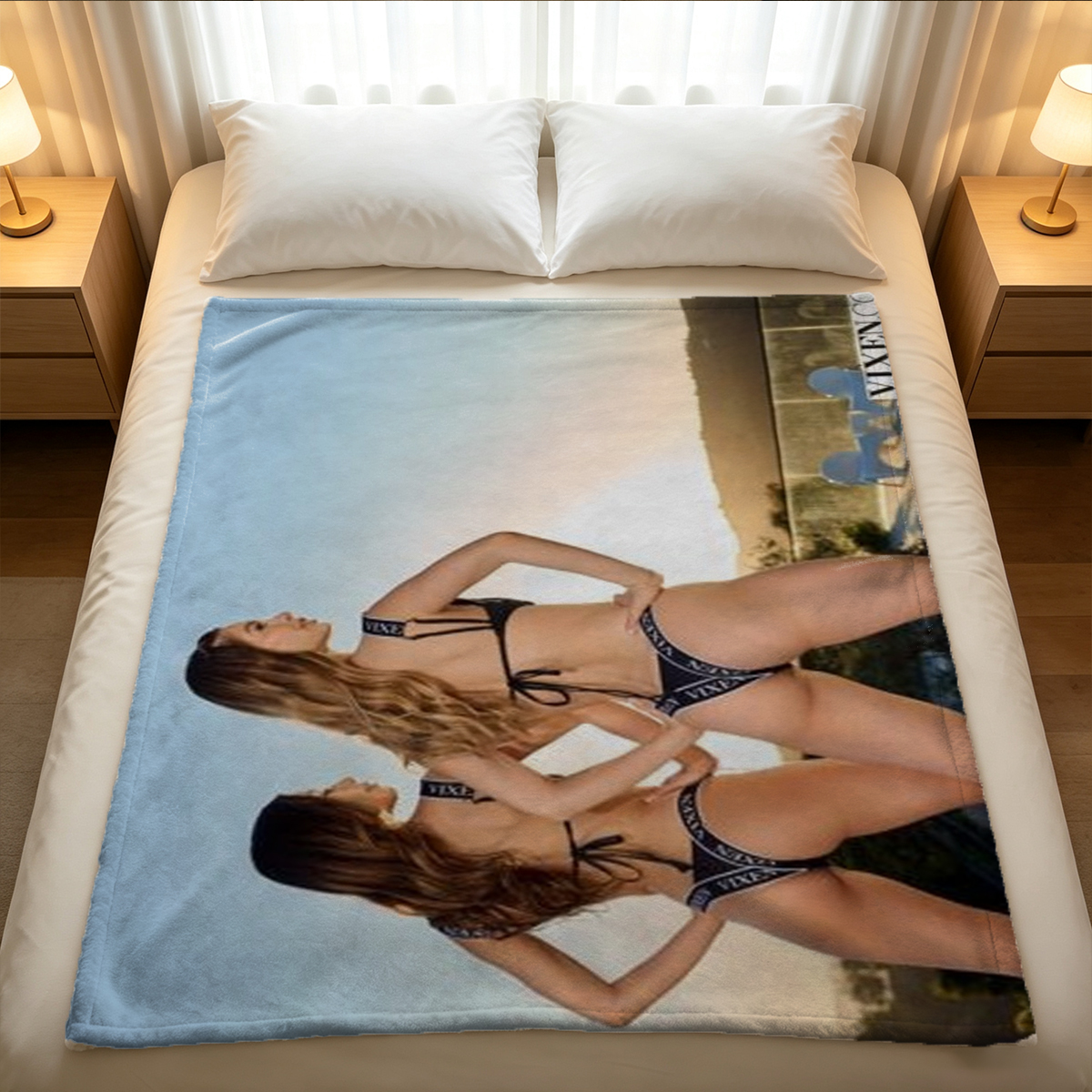 A woman in black lace lingerie and thigh garters lies seductively on a bed holding a feather tickler. - Blanket