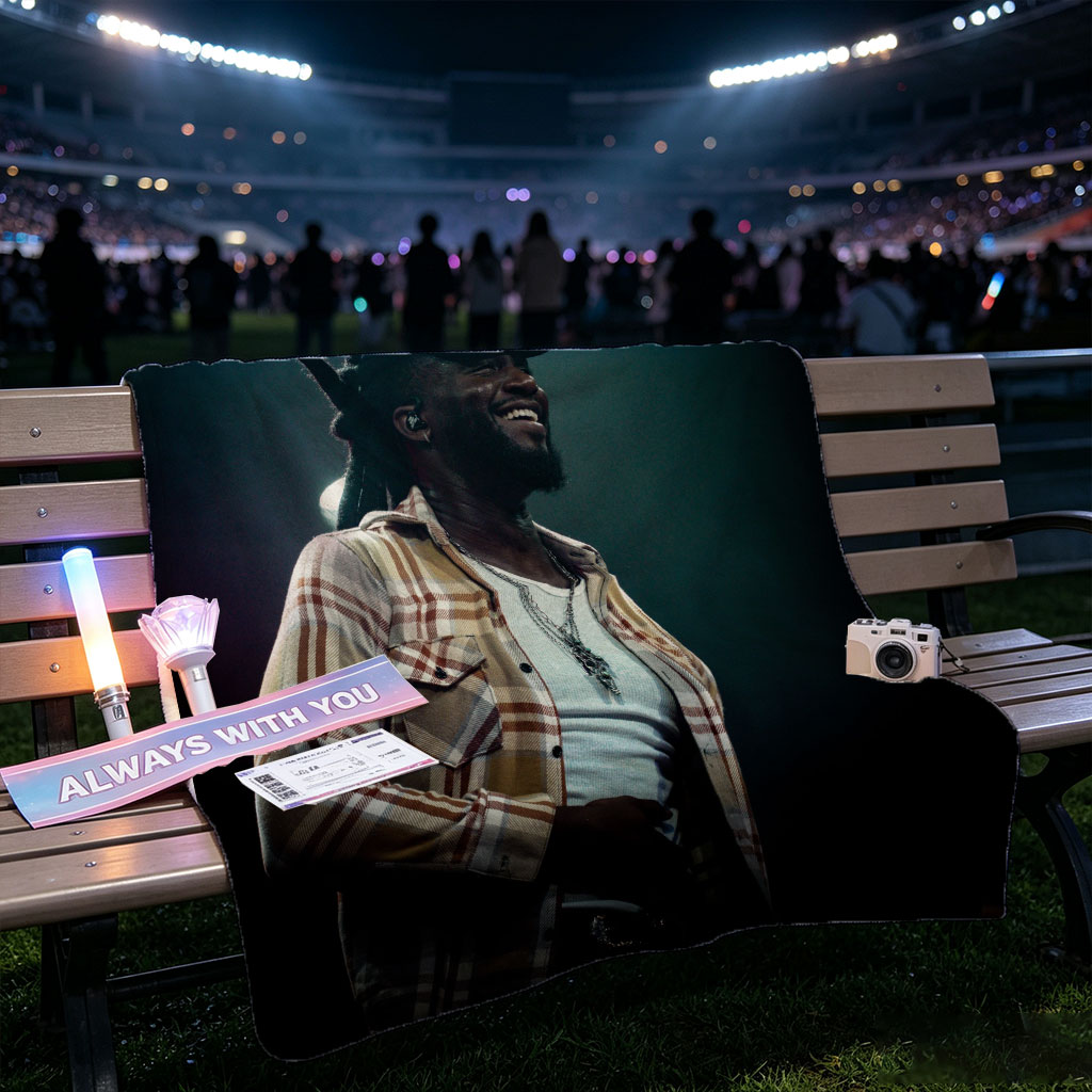 Burna Boy on Stage Performing with a Smile in a Plaid Shirt and Cap - Blankets