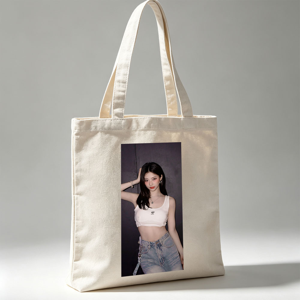 Korean Celebrity in Casual Outfit Wearing White Adidas Crop Top and High-Waisted Jeans Against Dark Background - Canvas tote bags