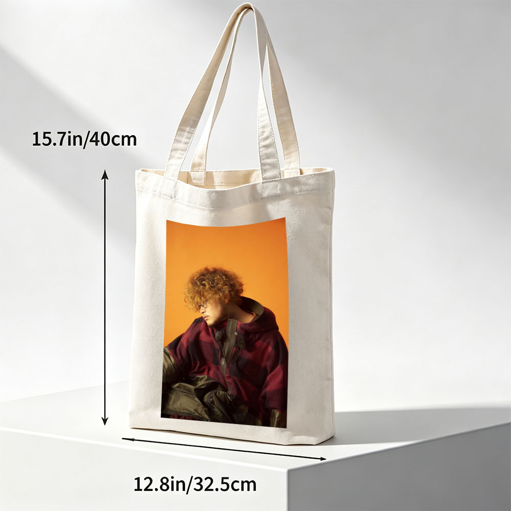 Takashi Miyagawa in a Moody Portrait Wearing a Plaid Hoodie Against an Orange Background - Canvas tote bags