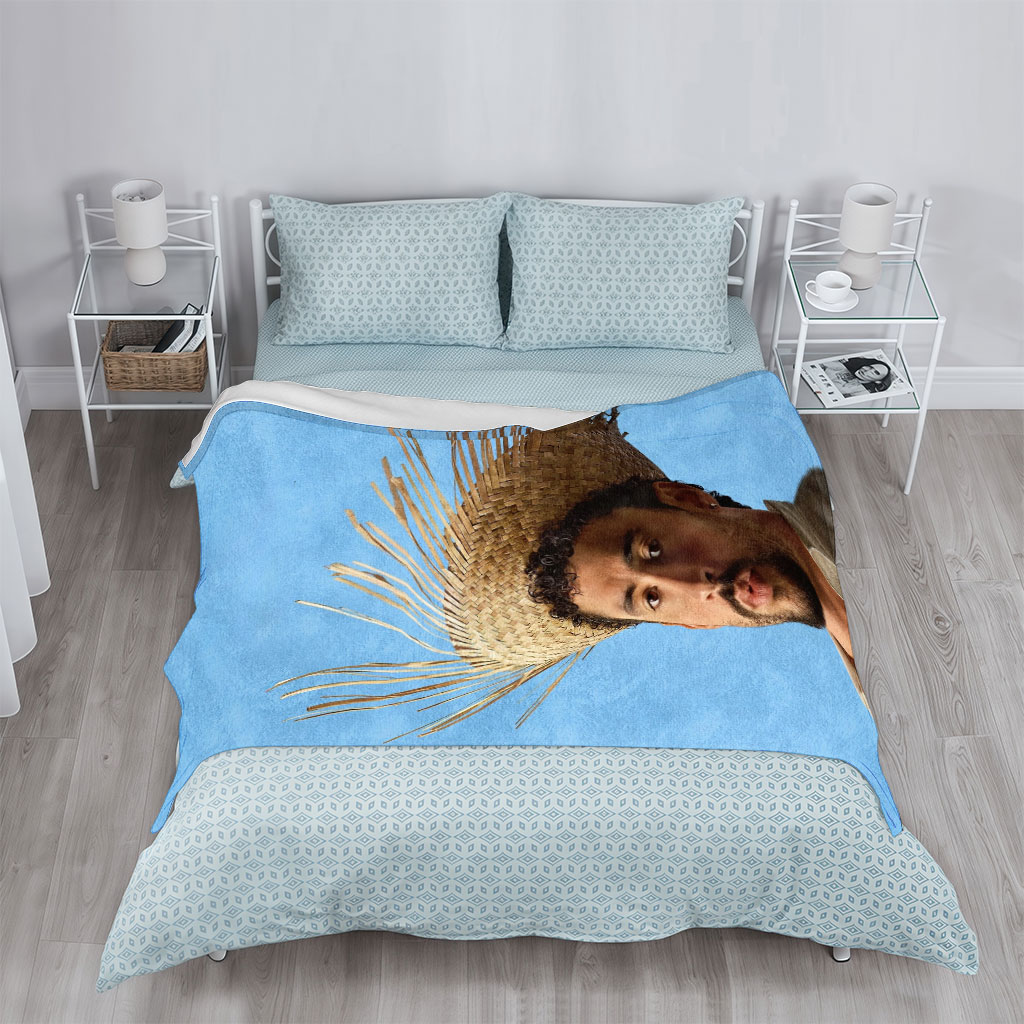 Bad Bunny Wearing a Straw Hat with Spiky Design Against a Blue Background - Blankets