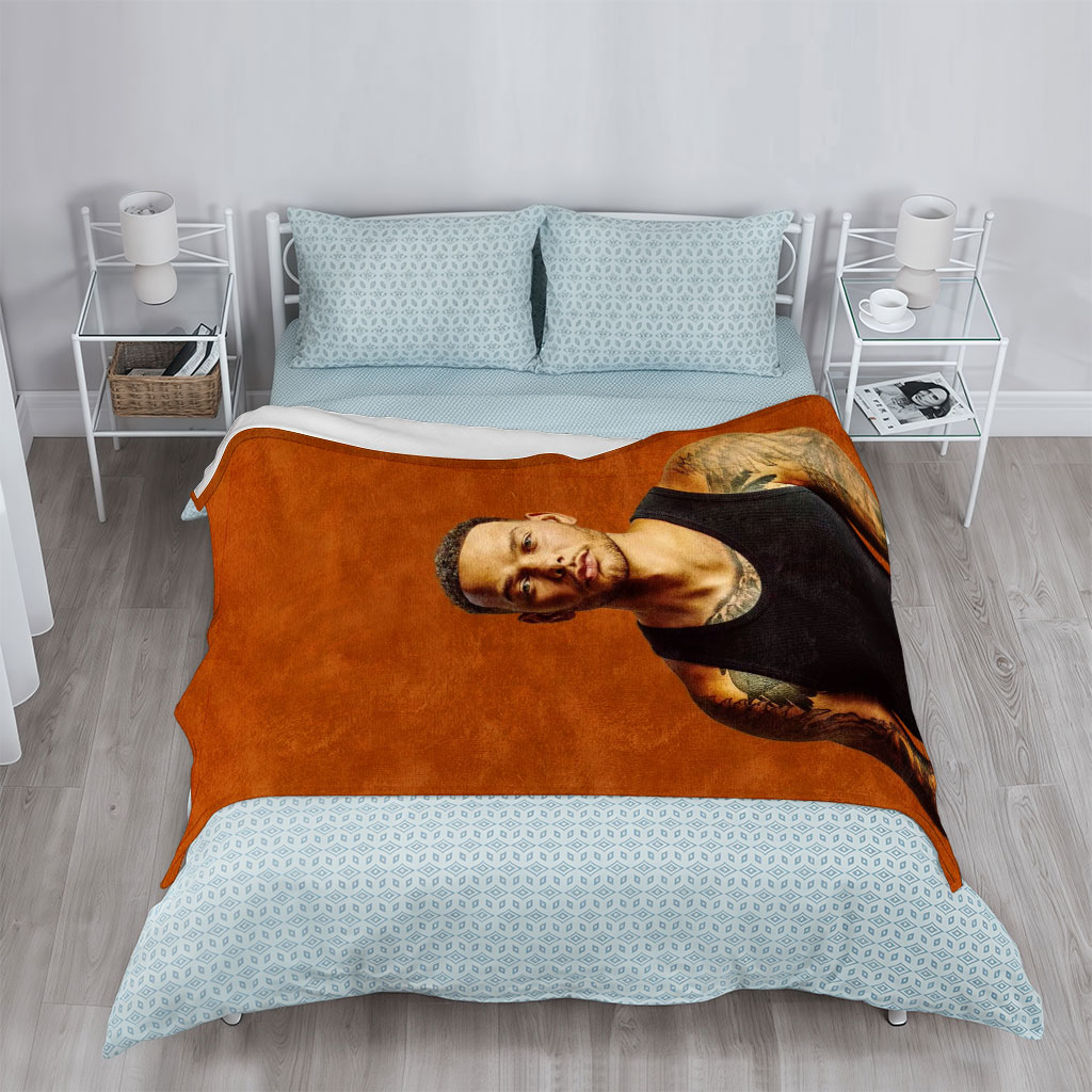 Liam Payne Standing in Black Tank Top with Visible Tattoos Against Orange Background - Blankets