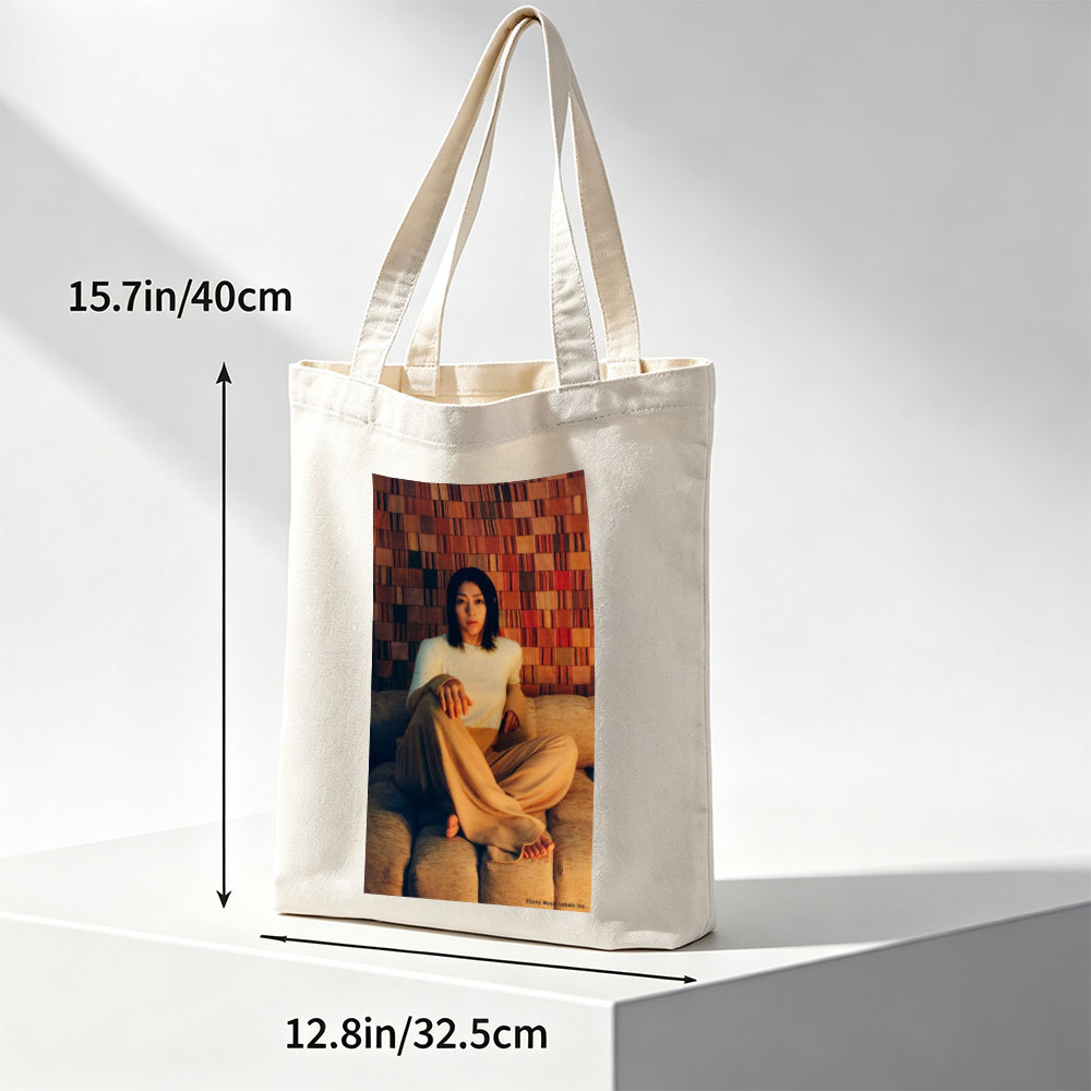 Ayaka Hirahara Sitting on Couch in Cozy Outfit Against Textured Wall Background - Canvas tote bags