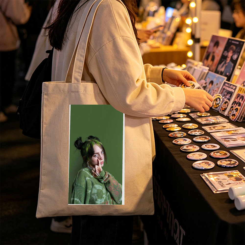 Billie Eilish in Studio Portrait Wearing Green Knit Sweater with Hair in Buns and Fingers on Face - Canvas tote bags