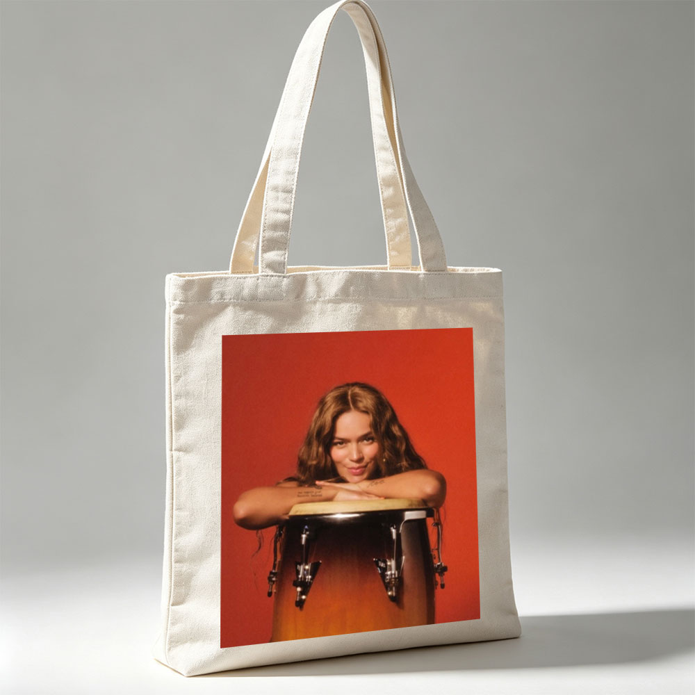 Maren Morris Leaning on a Conga Drum Against a Red Background - Canvas tote bags