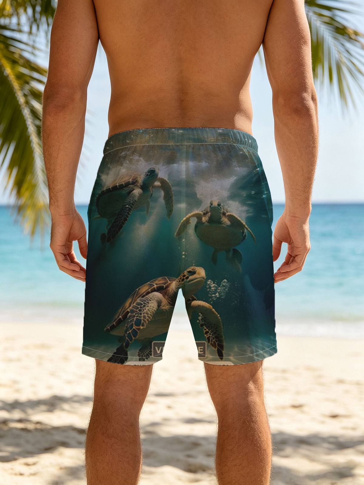 Three sea turtles swimming gracefully underwater in clear blue ocean. -  Beach shorts