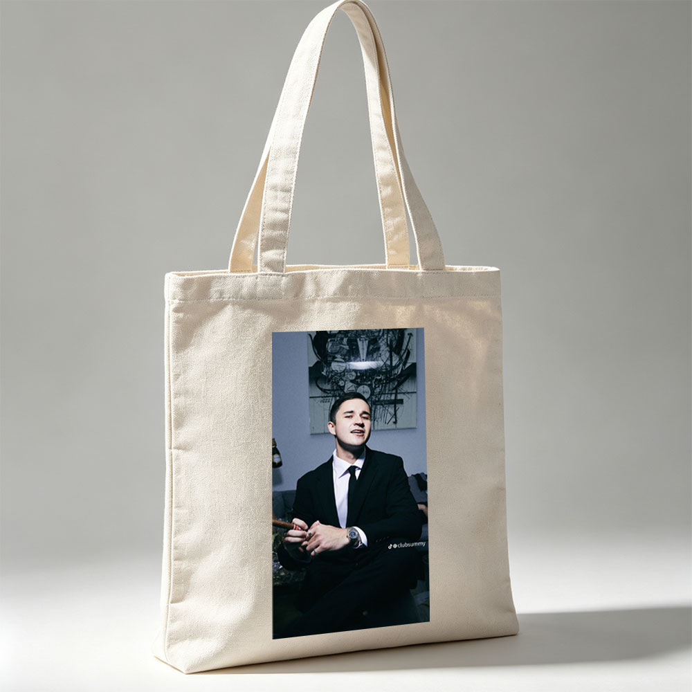 Pete Davidson in a Suit Holding a Cigar with Artwork in the Background - Canvas tote bags