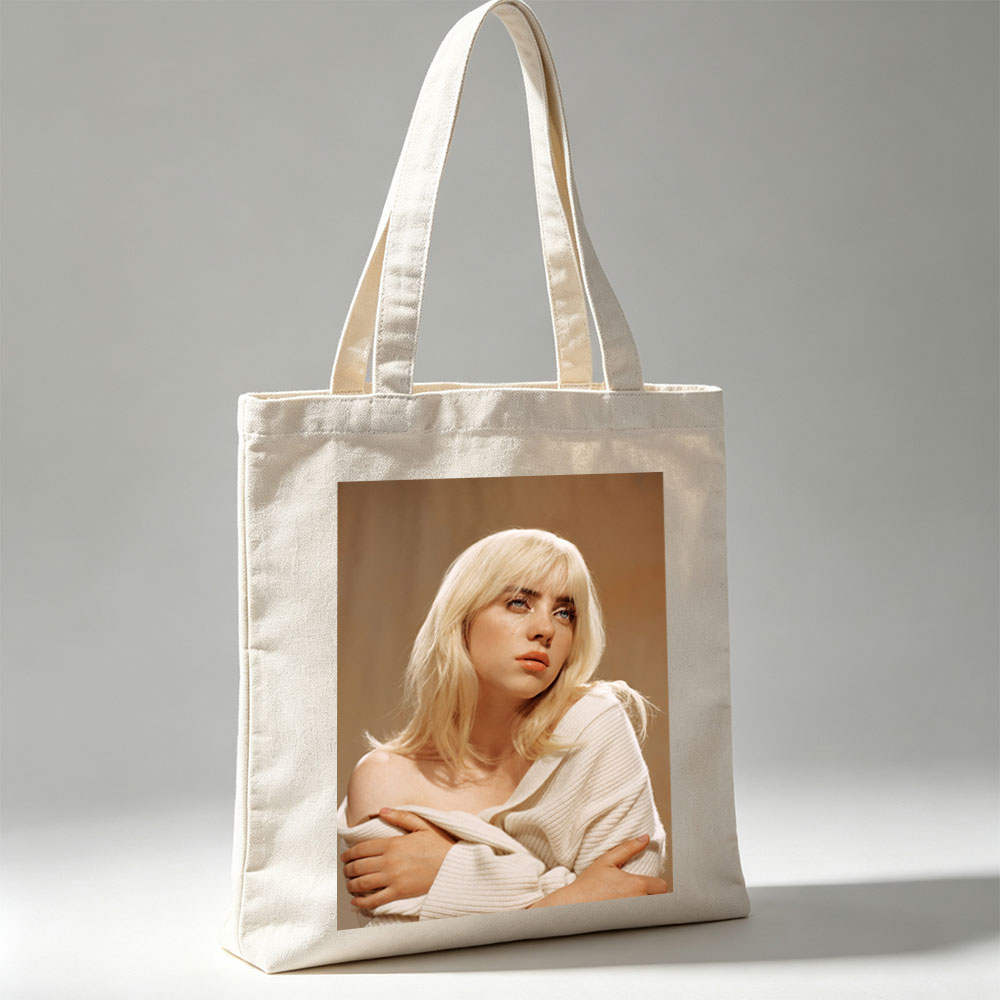 Billie Eilish in a Soft Portrait Wearing a White Off-Shoulder Sweater with Blonde Hair and Blue Eyes - Canvas tote bags