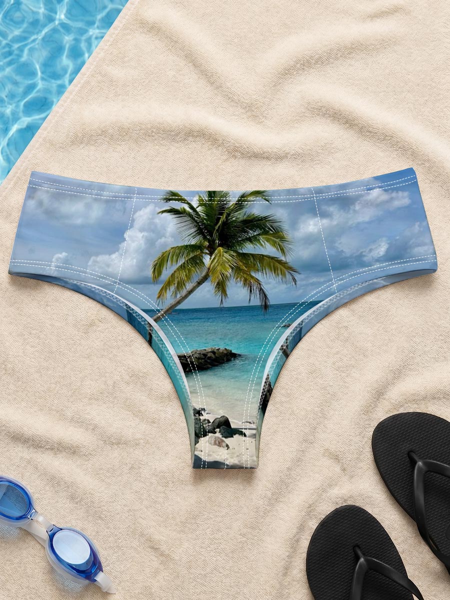 Tropical beach with palm tree leaning over turquoise water and white sand under blue sky. -  Men's swim trunks