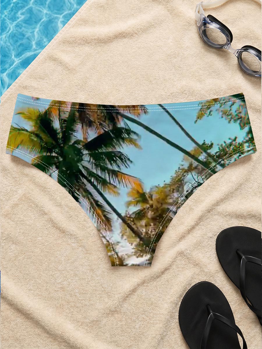 Tropical palm trees sway under a clear blue sky, casting golden shadows on the ground. -  Men's swim trunks