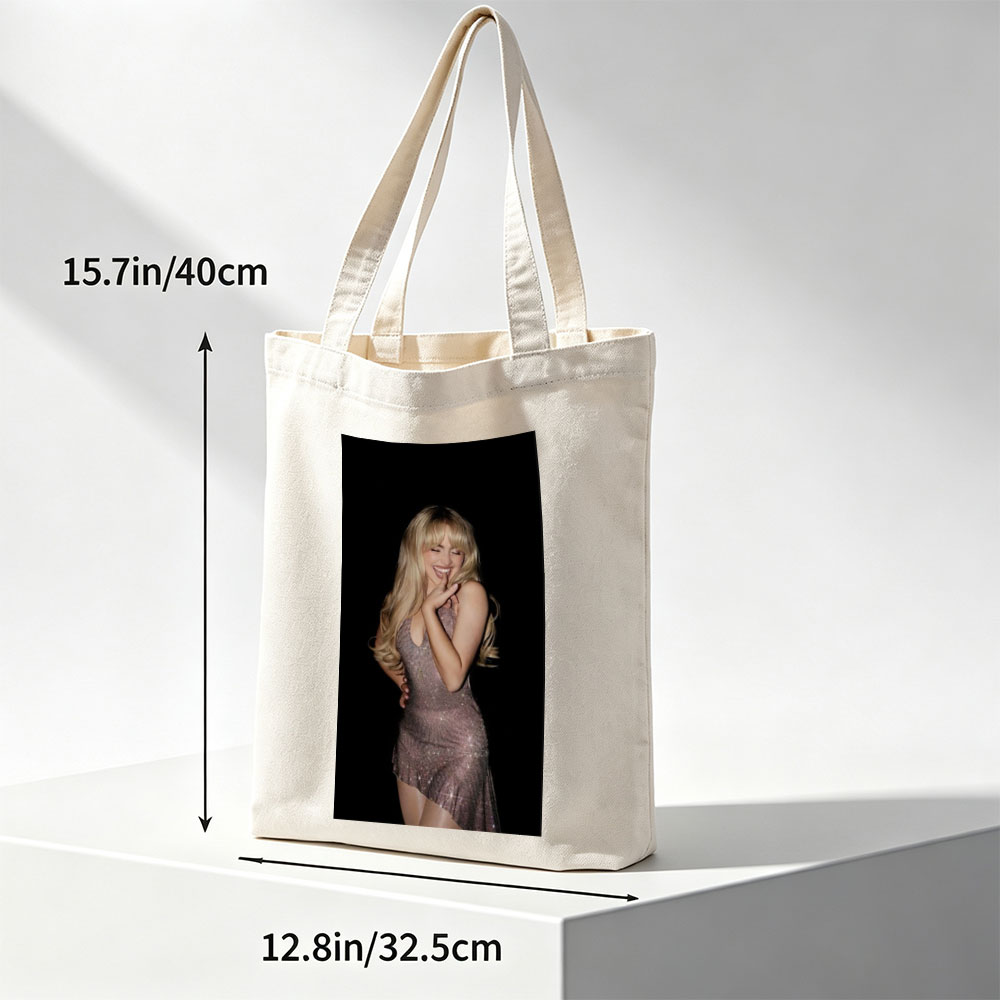 Sabrina Carpenter in a Sparkling Dress Posing with a Smile Against a Black Background - Canvas tote bags
