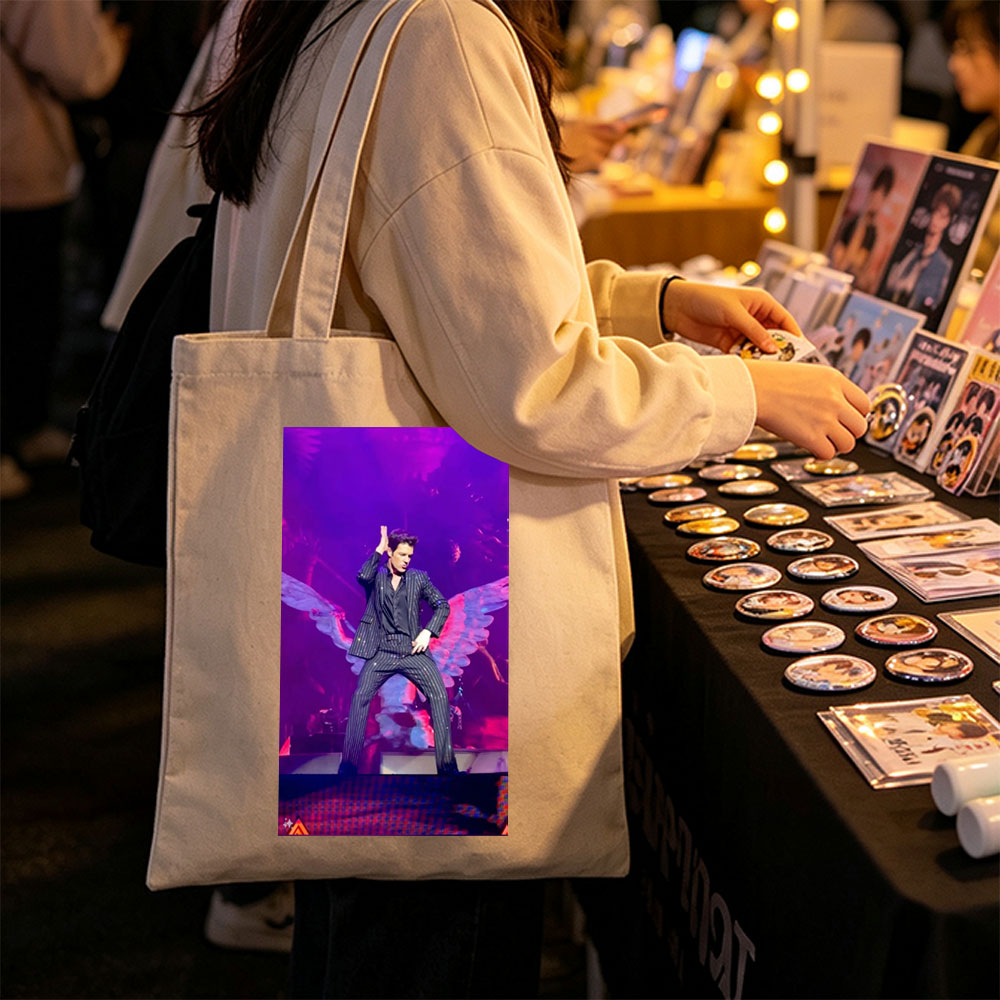 Adam Lambert on Stage in a Striped Suit with Dramatic Wing Props Under Purple Lighting - Canvas tote bags