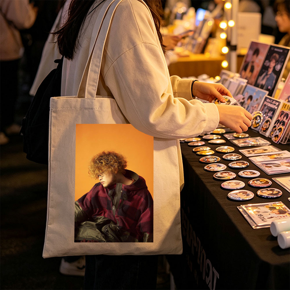 Takashi Miyagawa in a Moody Portrait Wearing a Plaid Hoodie Against an Orange Background - Canvas tote bags