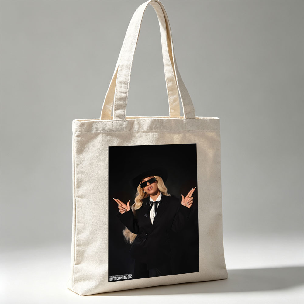 Beyonce in a Bold Black Suit and Hat Making Peace Signs Against a Dark Background - Canvas tote bags