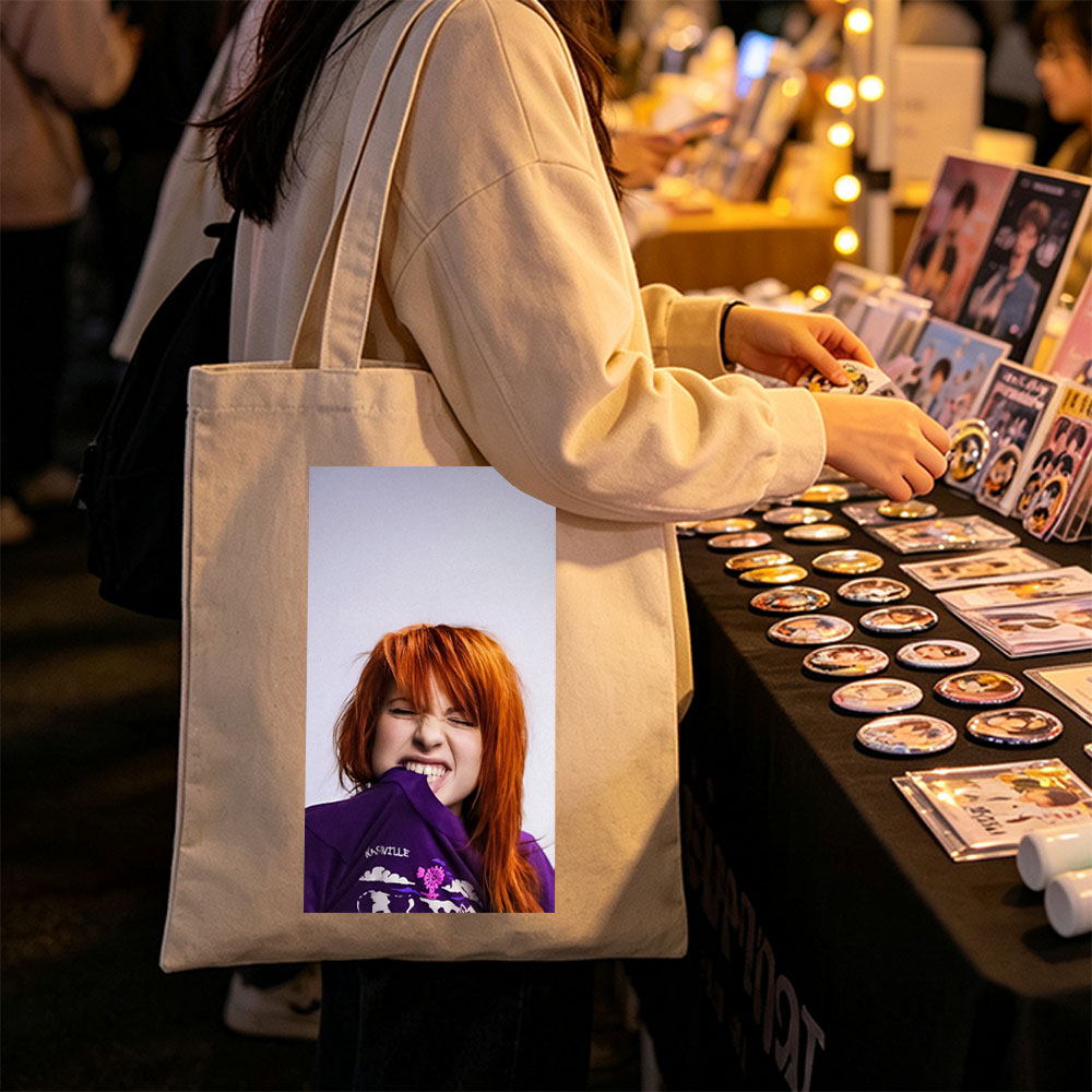 Hayley Williams from Paramore in a Playful Pose Wearing a Purple Nashville Shirt with a Vibrant Design - Canvas tote bags