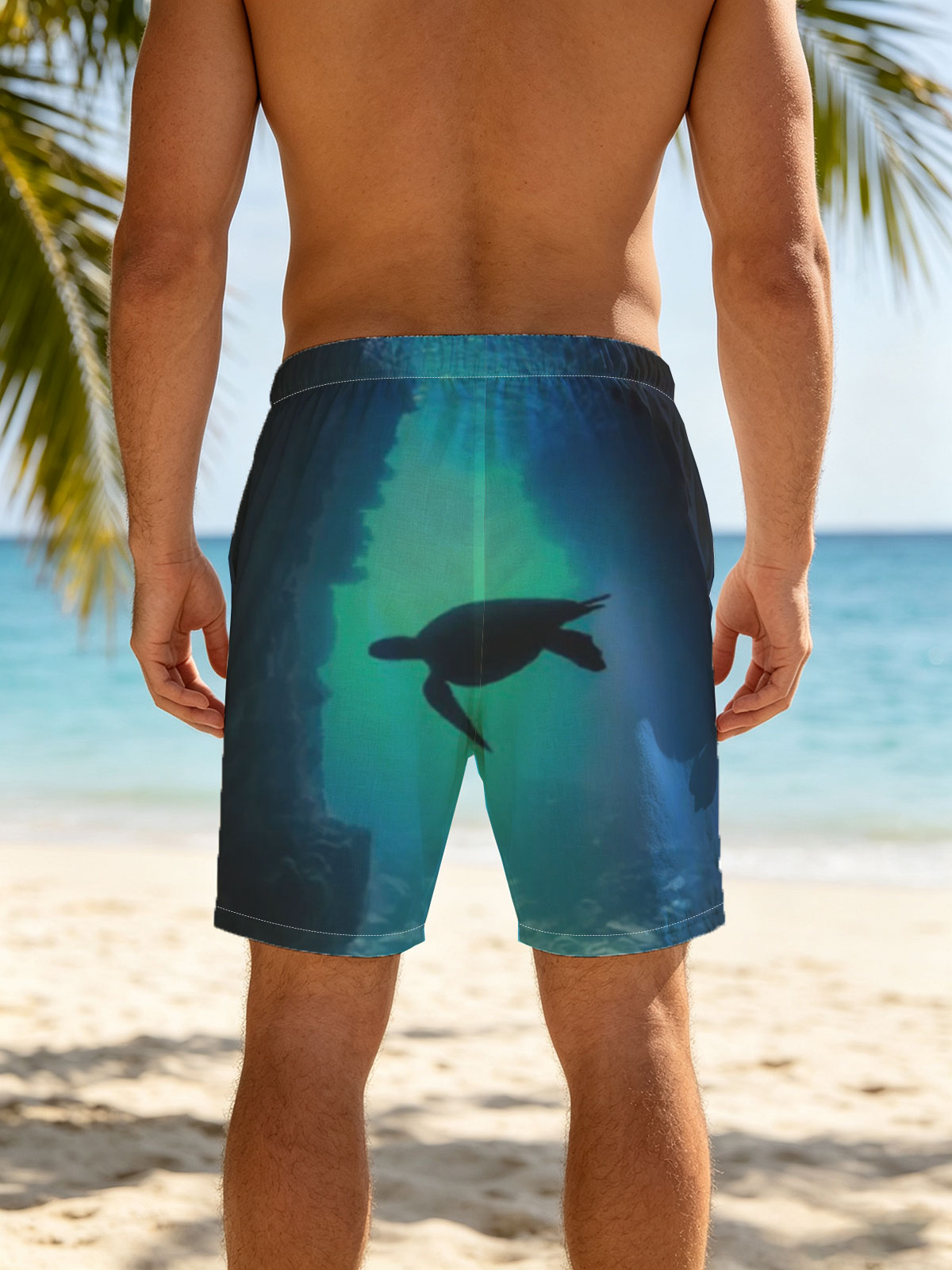 Sea turtle glides through a sunlit underwater cave. -  Beach shorts