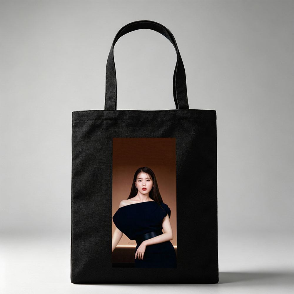 IU in Elegant Black Off-Shoulder Dress Against Warm Brown Background - Canvas tote bags
