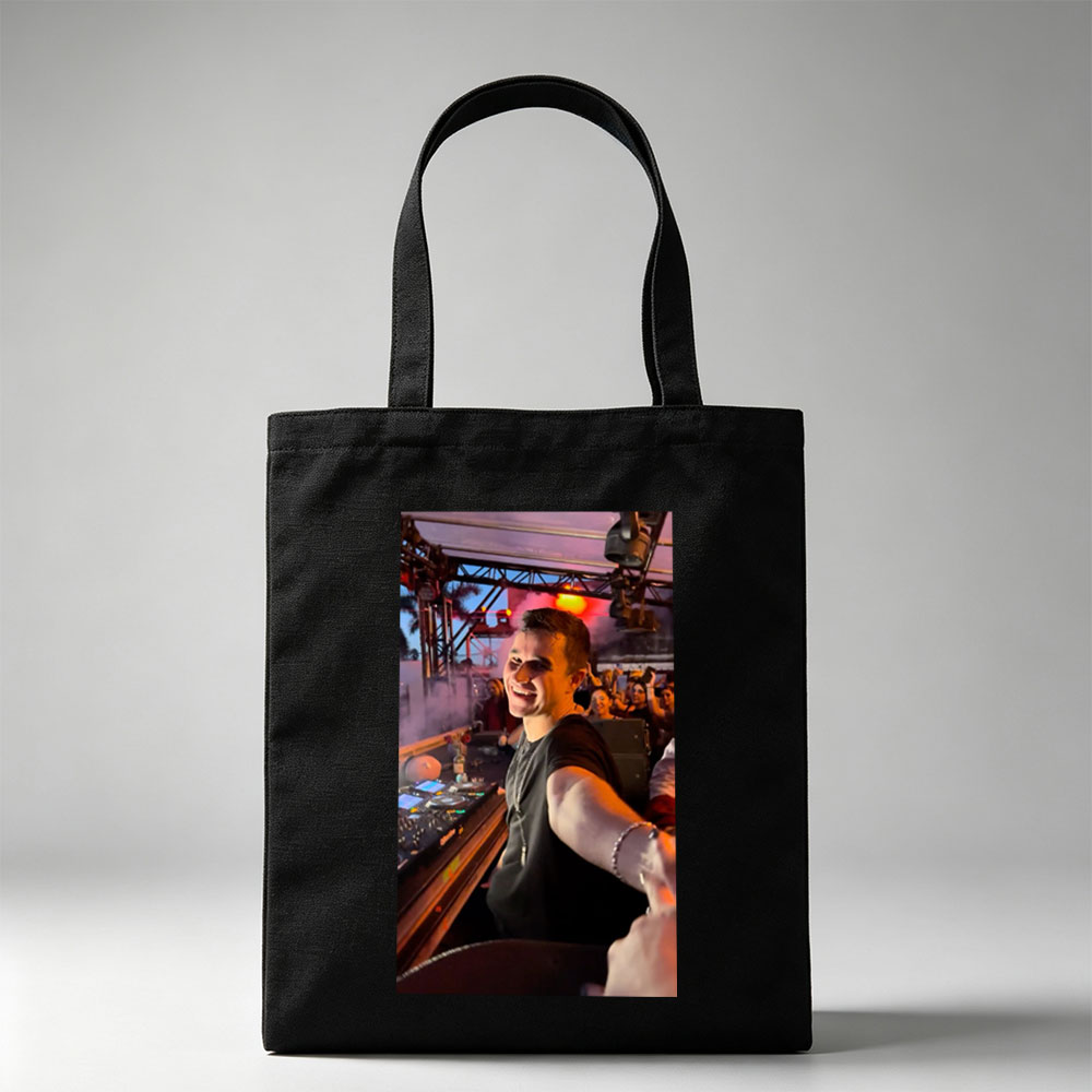 Martin Garrix at a Live DJ Set Performing for an Energetic Crowd Under Colorful Stage Lights - Canvas tote bags