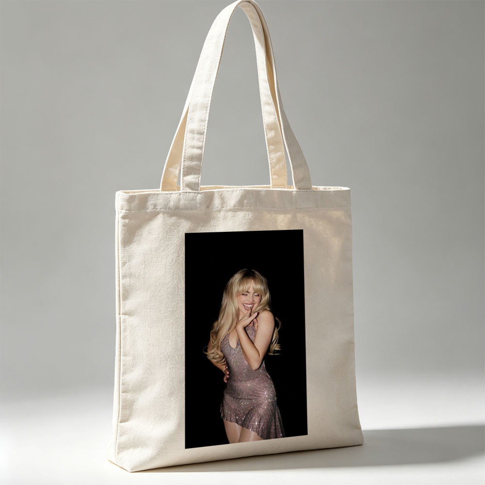 Sabrina Carpenter in a Sparkling Dress Posing with a Smile Against a Black Background - Canvas tote bags
