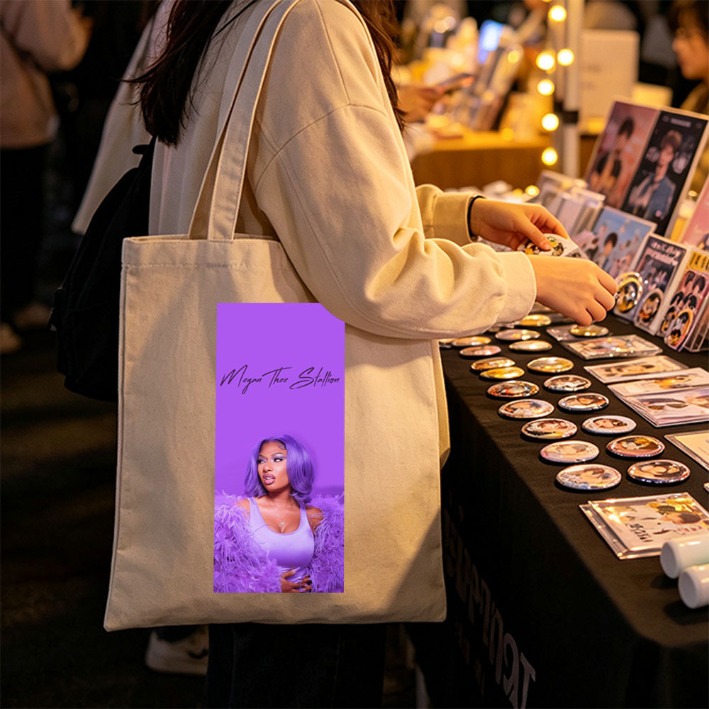 Megan Thee Stallion in Purple Feathered Outfit Against Vibrant Purple Background - Canvas tote bags