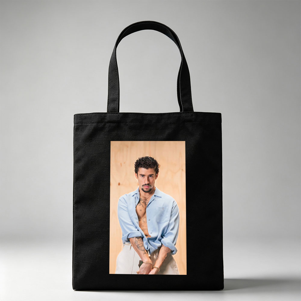 Bad Bunny in a Casual Pose Wearing an Open Light Blue Shirt and White Pants with Visible Tattoos - Canvas tote bags