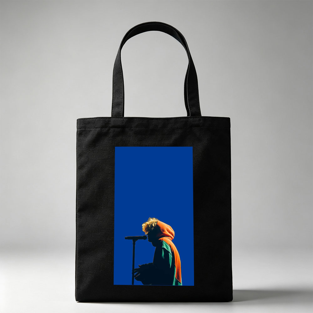 Troye Sivan Performing on Stage with Microphone Against Blue Background - Canvas tote bags