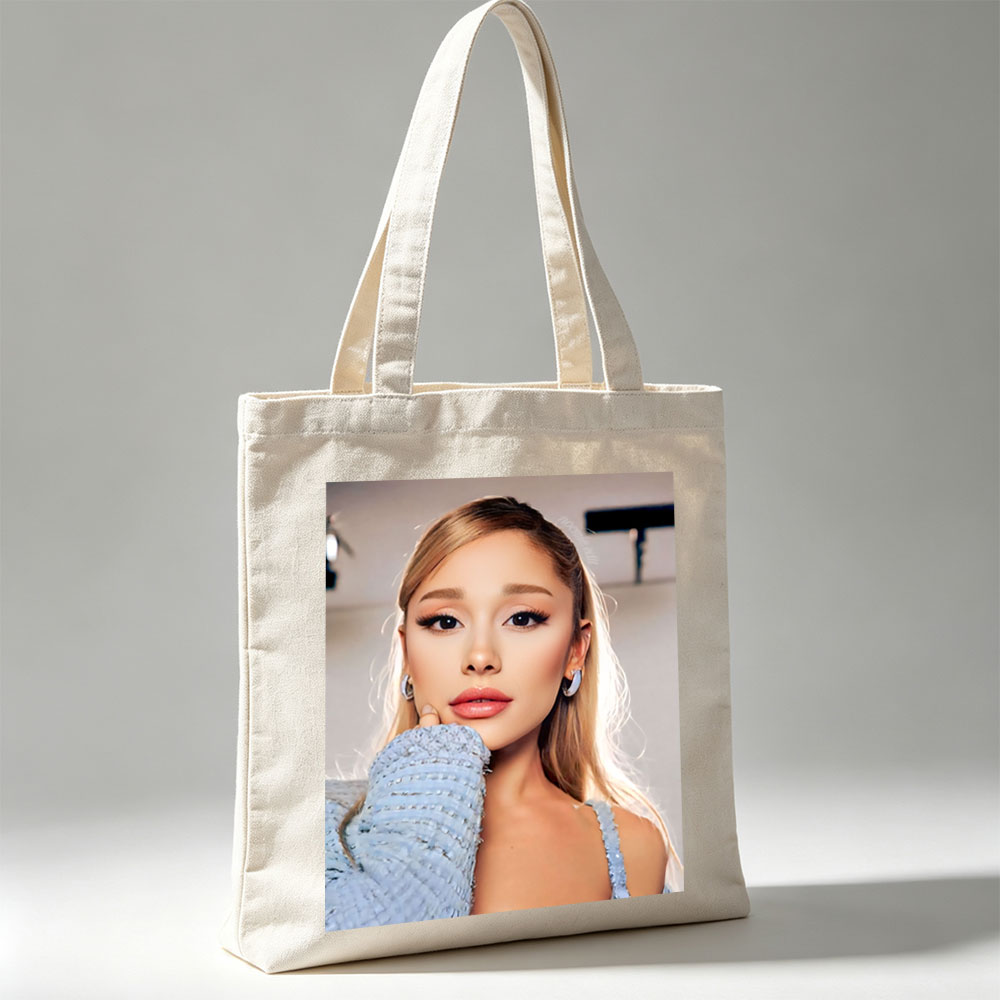 Ariana Grande in a Serene Moment Wearing a Light Blue Textured Top and Elegant Earrings - Canvas tote bags