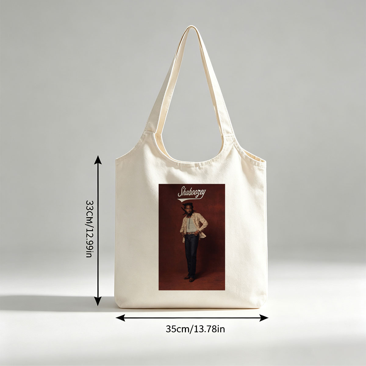 Shaboozey Standing Confidently in a Patterned Jacket and Jeans Against a Rich Red Background - Canvas shoulder bags/