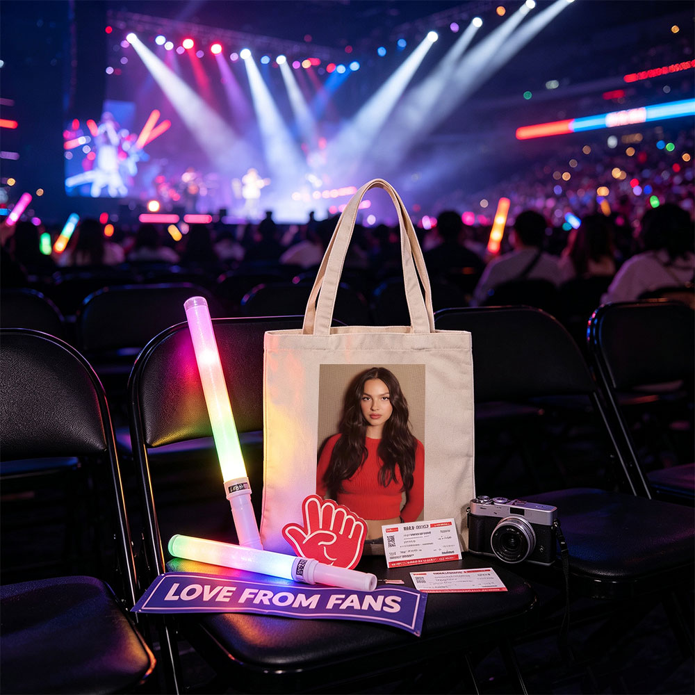 Olivia Rodrigo in a Bold Red Crop Top and Jeans, Striking a Confident Pose Against a Textured Background - Canvas tote bags