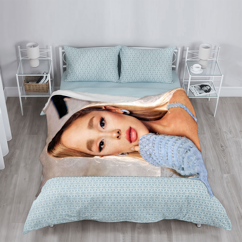 Ariana Grande in a Serene Moment Wearing a Light Blue Textured Top and Elegant Earrings - Blankets
