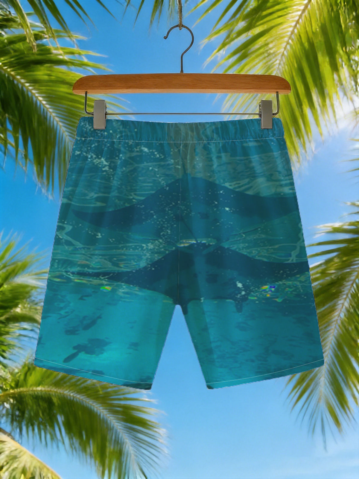 Graceful manta rays glide through clear blue waters, their silhouettes dancing beneath the surface. -  Beach shorts