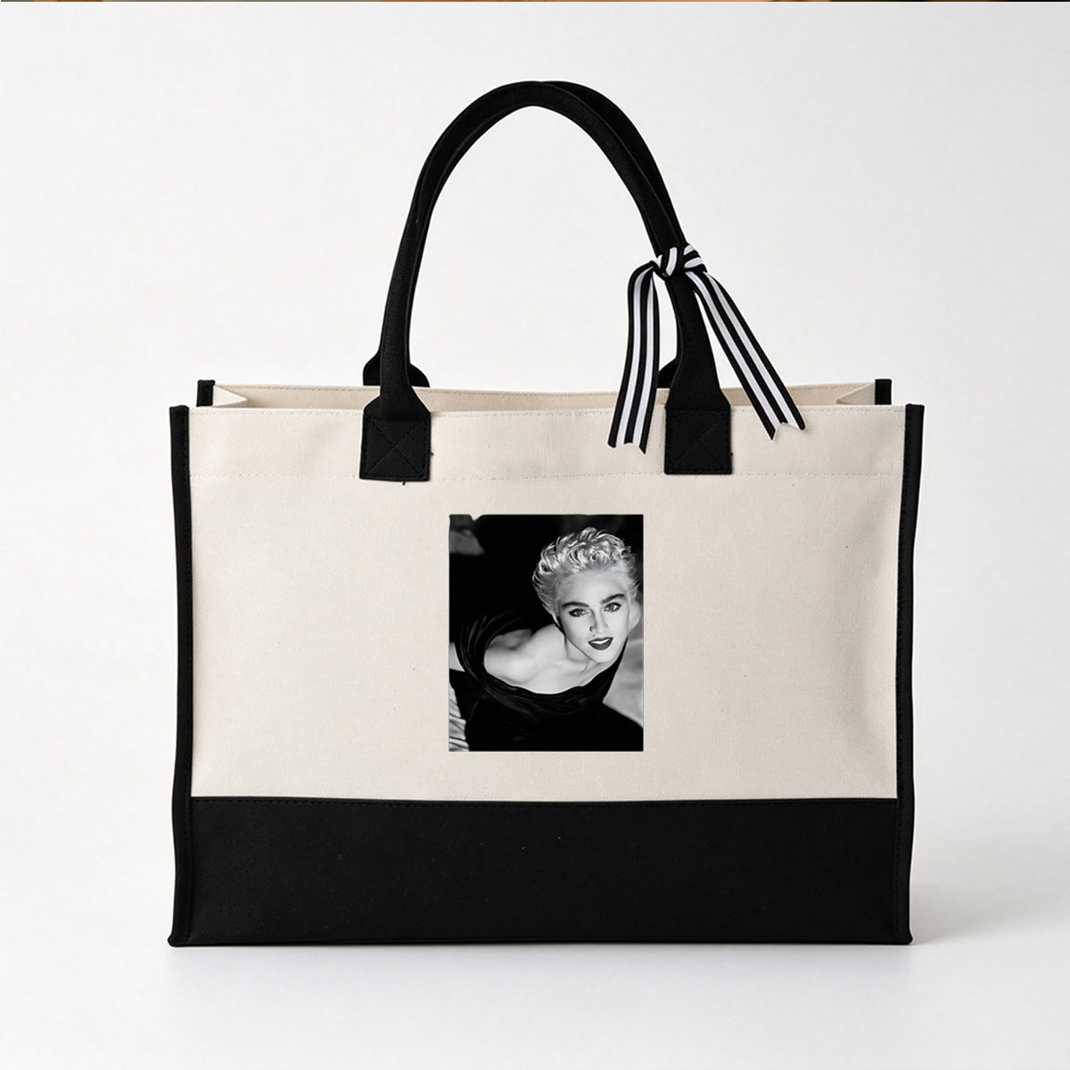 Madonna in a striking black and white portrait, showcasing bold makeup and voluminous blonde hair. - Canvas patchwork gift tote bag