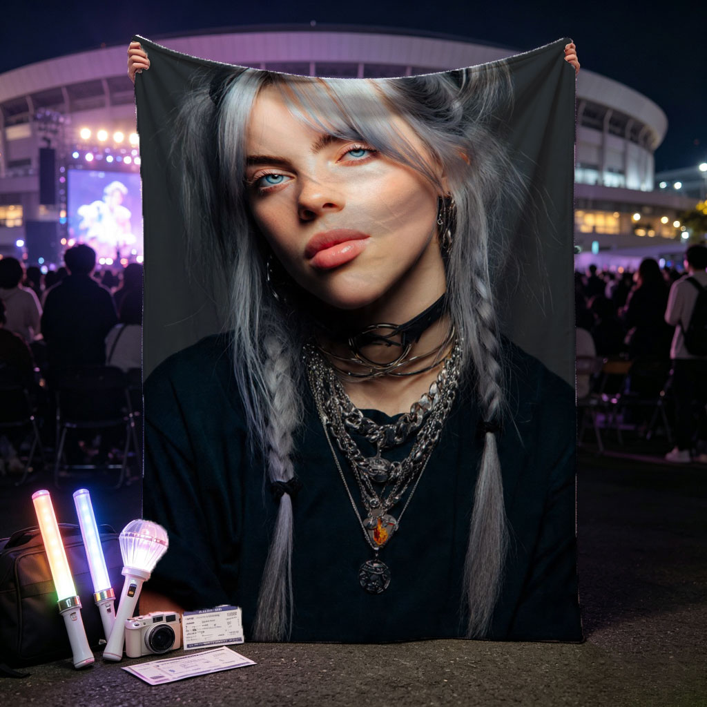 Billie Eilish in a striking portrait with silver hair styled in braids, wearing layered necklaces and a black top against a dark background. - Blankets