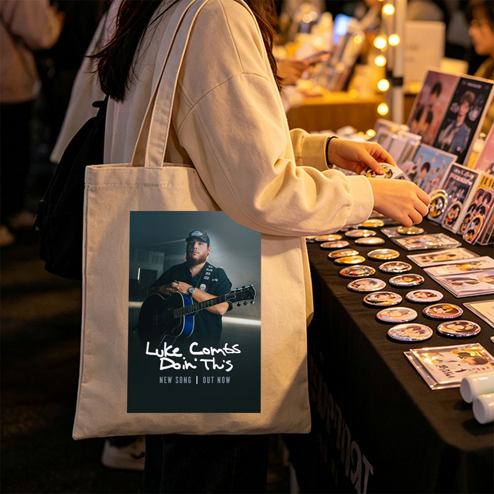 Luke Combs Holding Acoustic Guitar in Dark Studio Setting for New Song Release - Canvas tote bags