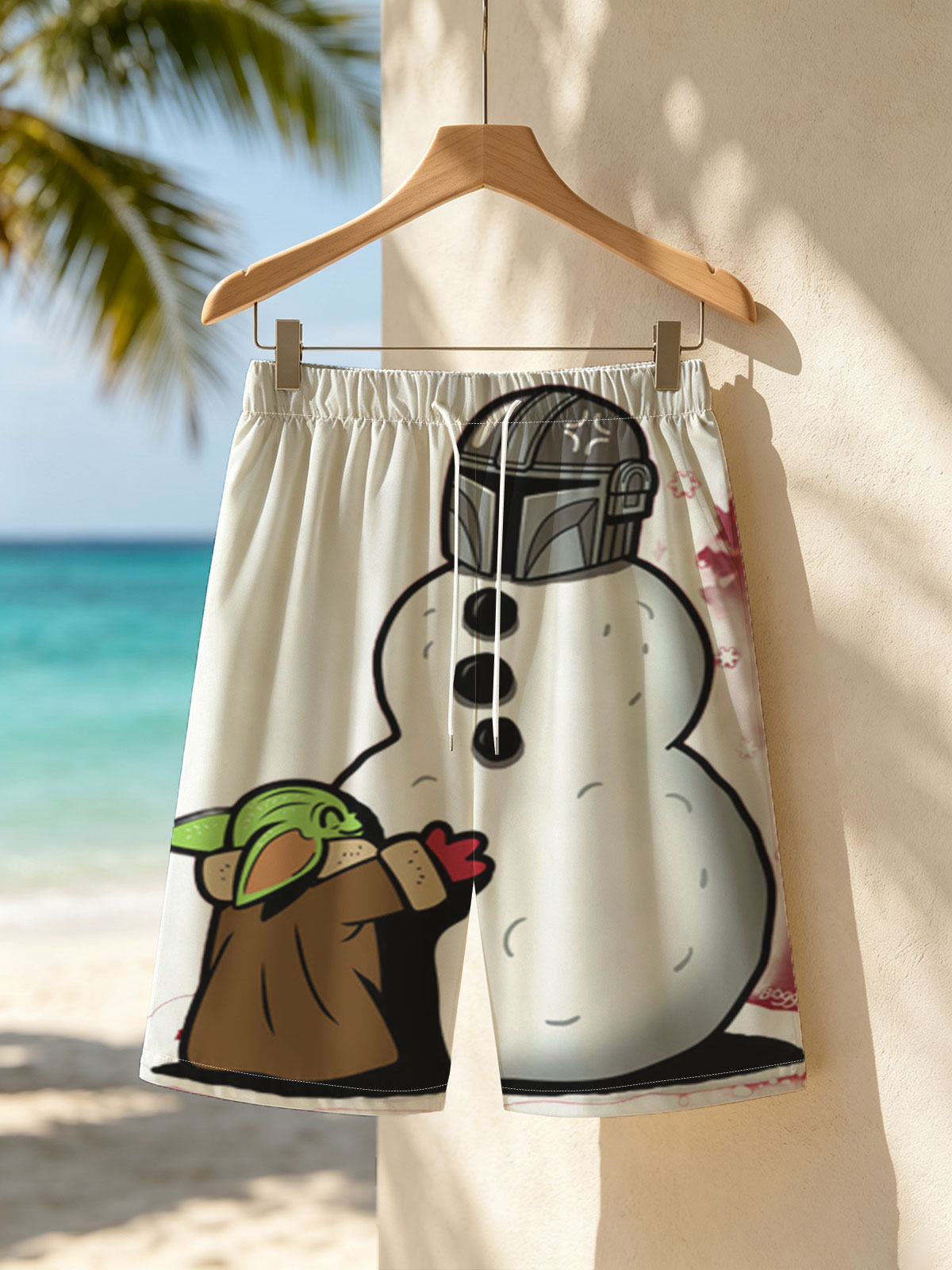 Baby Yoda Builds a Snowman with Mandalorian Helmet -  Beach shorts
