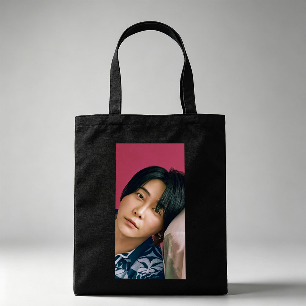 Yoshiki Hayashi in a Serene Pose Against a Vibrant Pink Background Wearing a Traditional Patterned Outfit - Canvas tote bags
