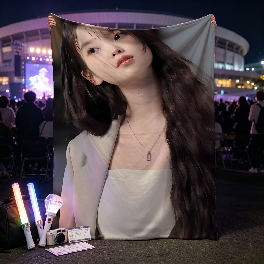 IU in a stylish outfit with a beige blazer and white crop top, showcasing her long wavy hair and elegant necklace. - Blankets