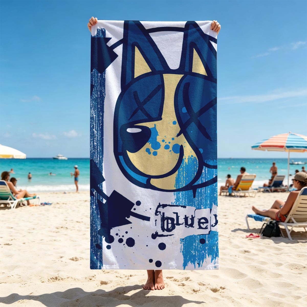Bluey-182: A stylized blue and yellow cat face with X eyes, arrows, and splatter effects on a textured blue background. - Beach towels