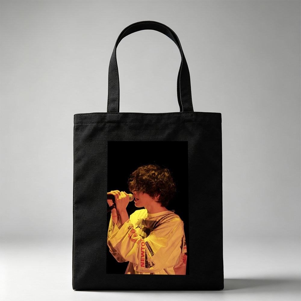 Harry Styles Singing on Stage in a Yellow Outfit with Microphone - Canvas tote bags
