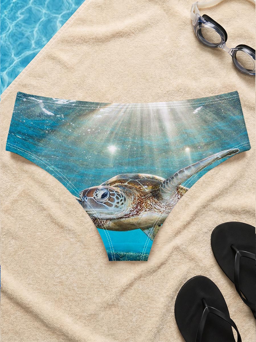 Sea turtle glides through sunlit coral reef -  Men's swim trunks