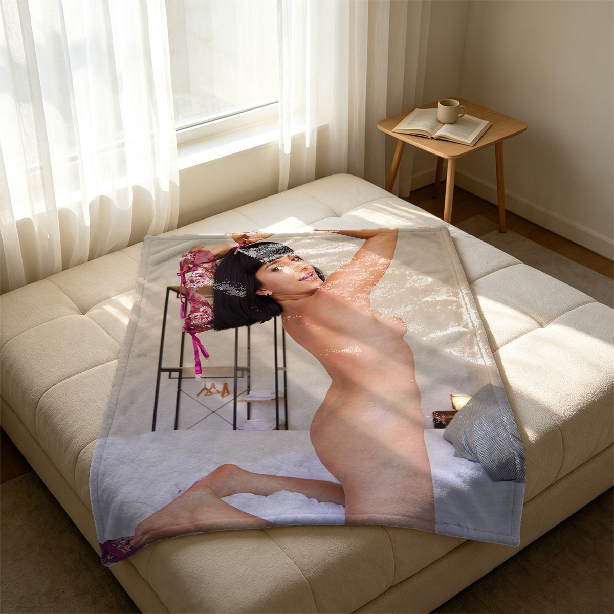 A woman in a black sleeveless bodysuit posing on a beige armchair in a modern hotel room. - Blanket