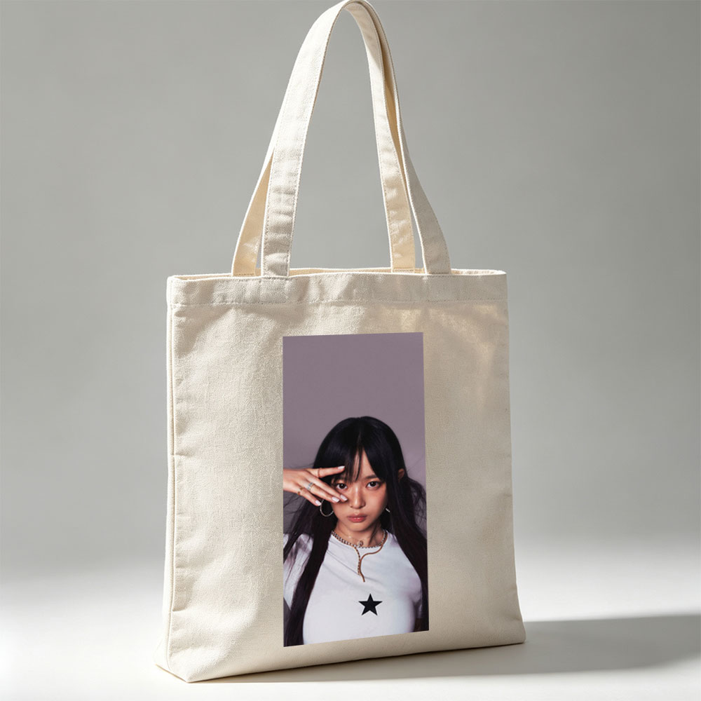 Hanni of NewJeans in a Stylish Pose with Star-Printed White Top and Elegant Jewelry - Canvas tote bags