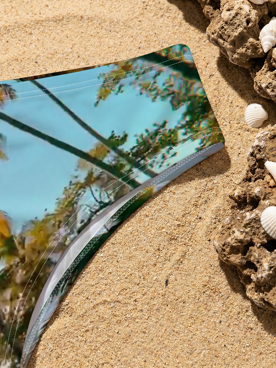 Tropical palm trees sway under a clear blue sky, casting golden shadows on the ground. -  Men's swim trunks