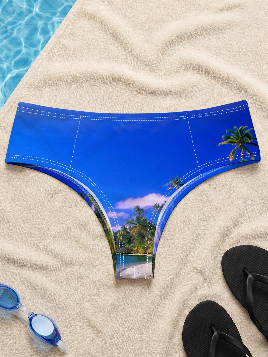 Seagulls soar over a pristine tropical beach with crystal-clear waters and palm trees under a vibrant blue sky. -  Men's swim trunks