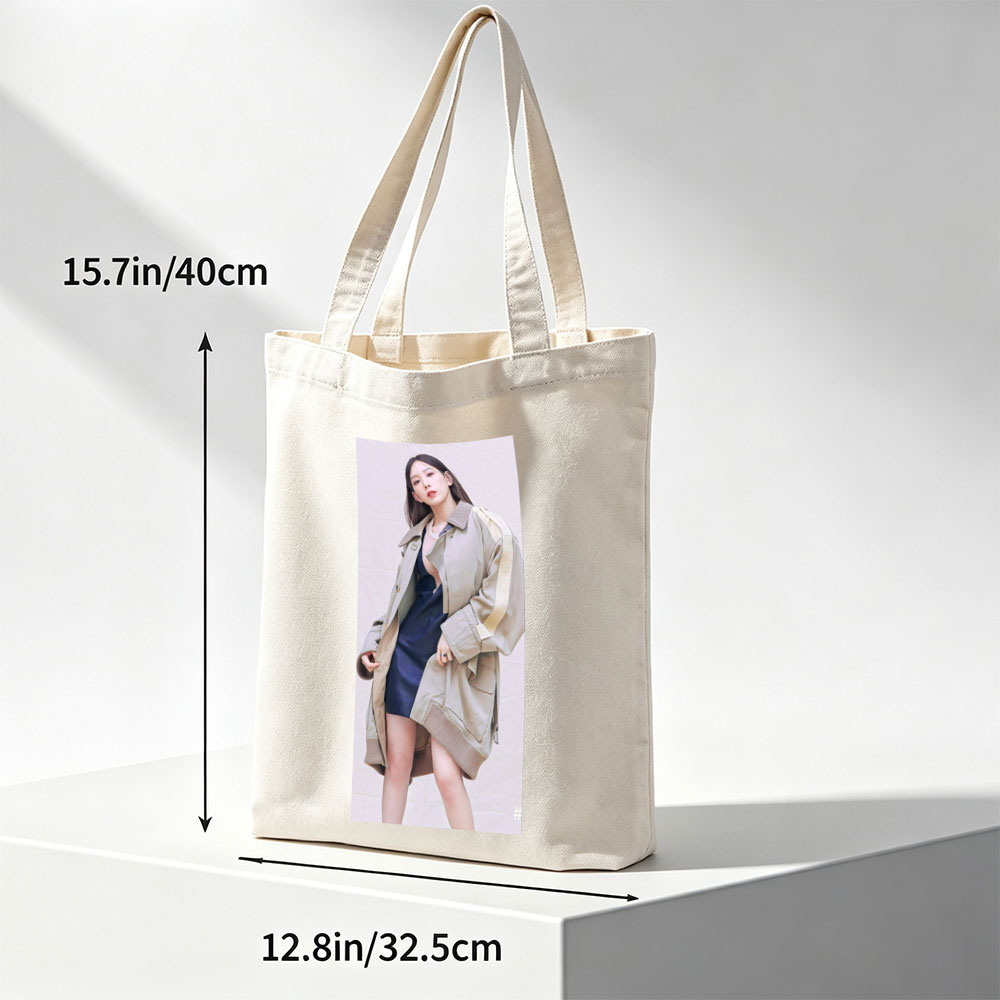 Kim Go Eun in a stylish urban look wearing a beige oversized coat over a navy blue dress, posing confidently against a neutral backdrop. - Canvas tote bags