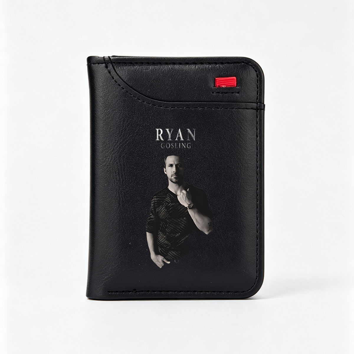 Ryan Gosling in a stylish black shirt, posing with hand on chest against dark background - Vertical Style Wallet